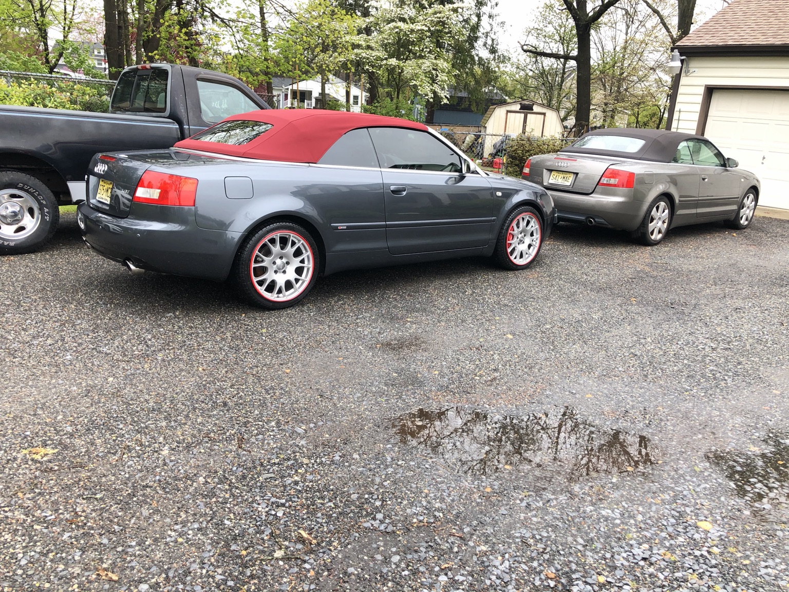 Hanz with red convertible top parked in front of the brown Audi Cabriolet named Coffee