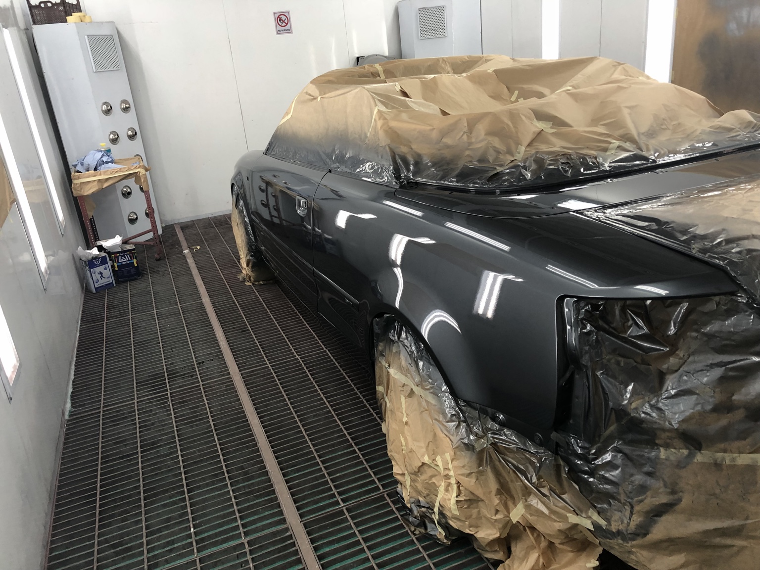 Hanz masked in a paint booth after receiving a fresh metallic paint finish